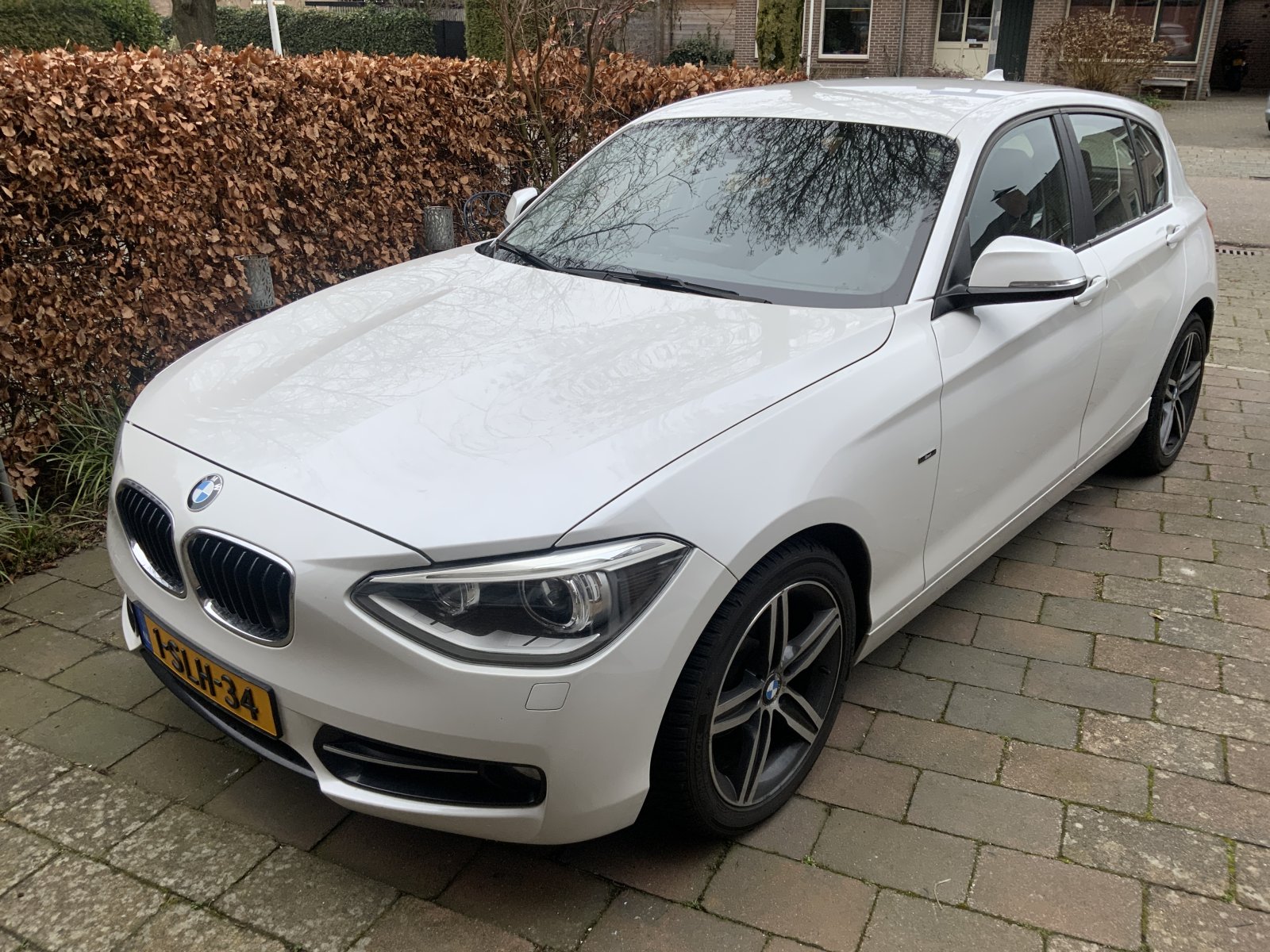 BMW 1-serie 116i EDE High Exe. 2013 - voorkant