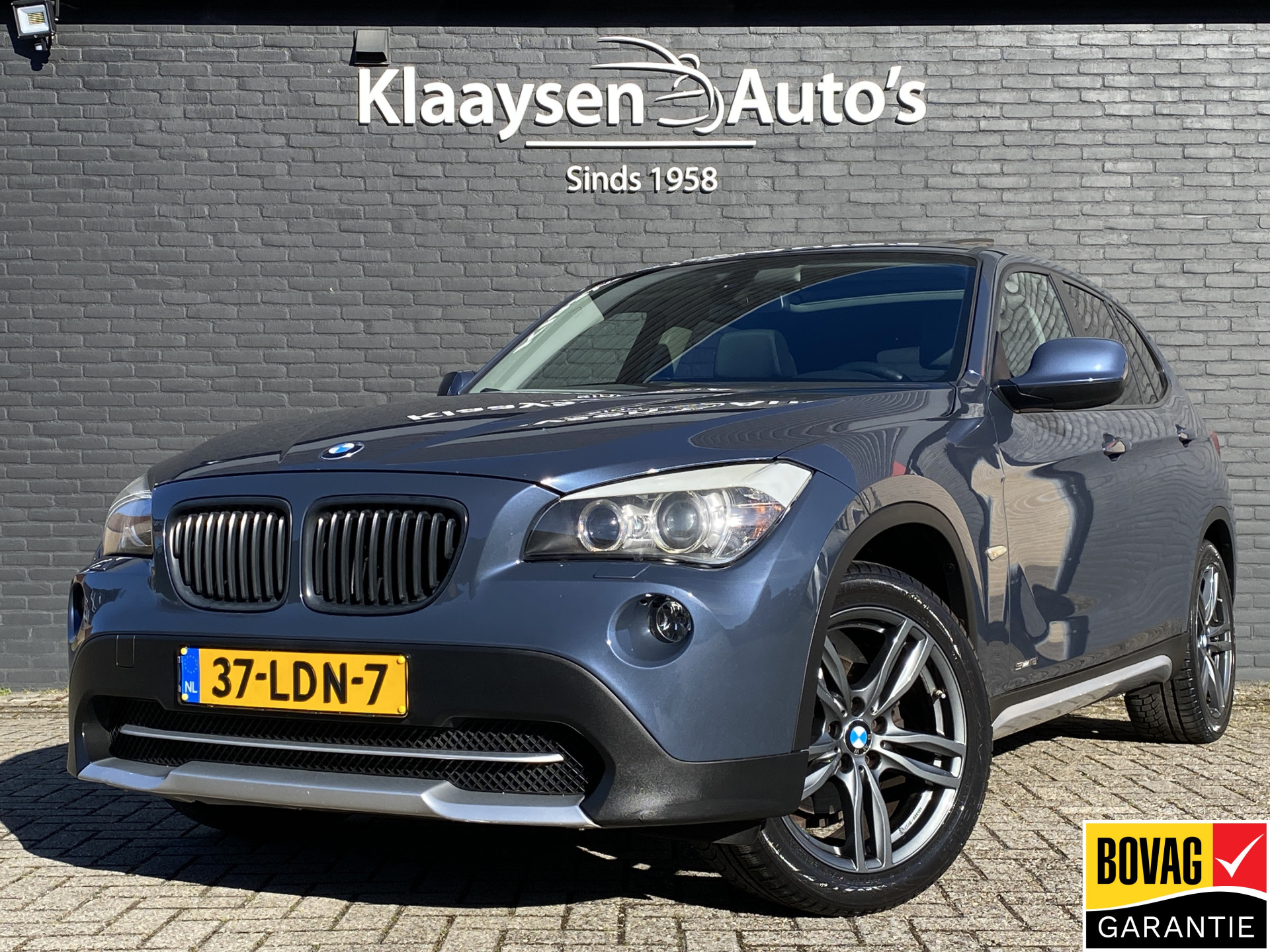 BMW X1 sDrive 18i sDrive18i Executive AUT. | navigatie | panoramadak | sportstoelen | xenon verlichting | lichtmetalen velgen 18 inch 2010 - voorkant