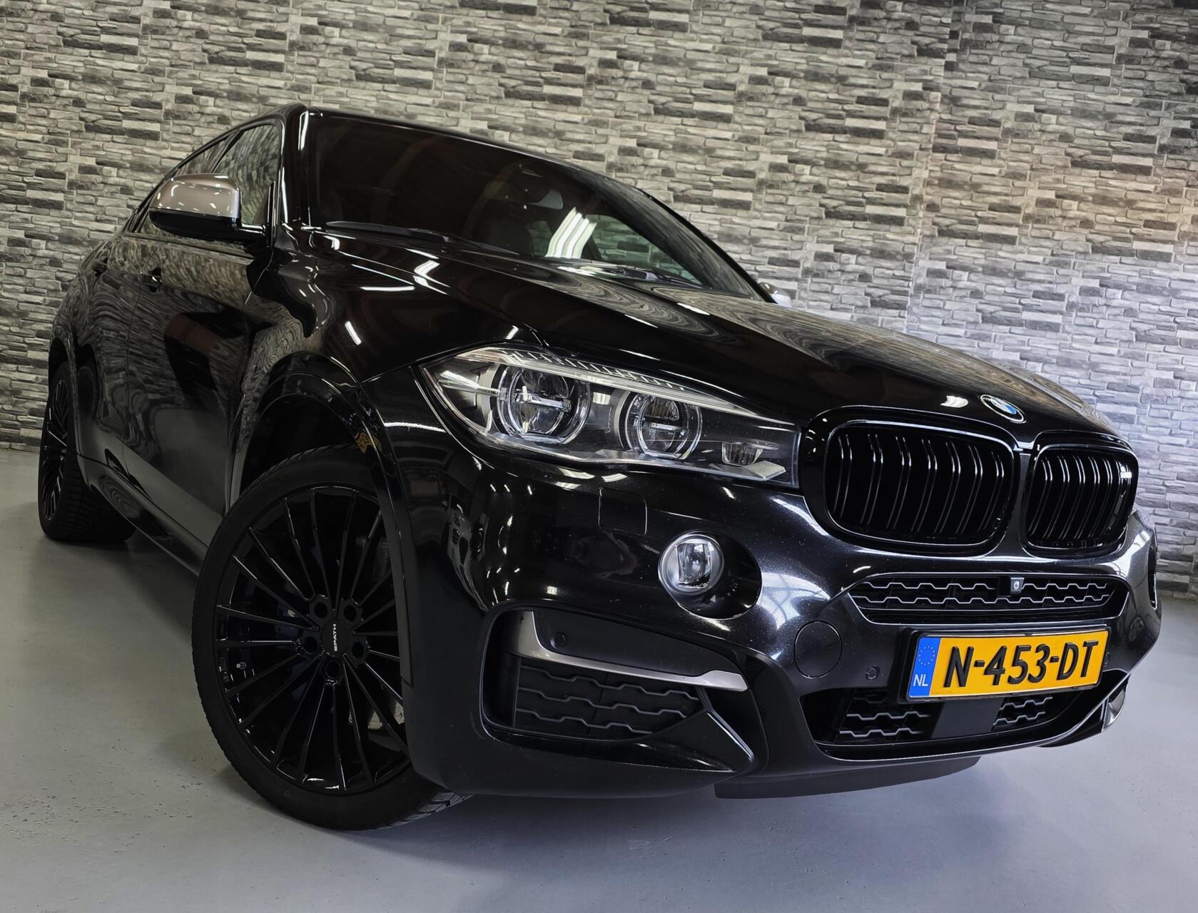 Foto van BMW X6 M50d
