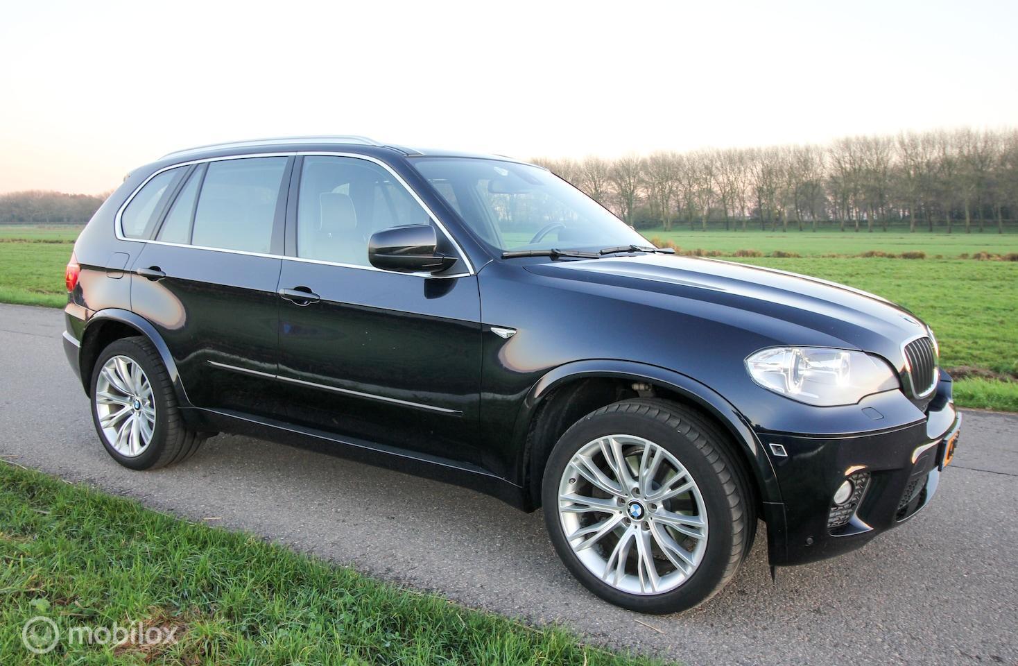 BMW X5 3.5i High Executive M-sportpakket E70 LCI Carbonschwarz Bruin Merino leer Panoramadak Historie 2011 - voorkant
