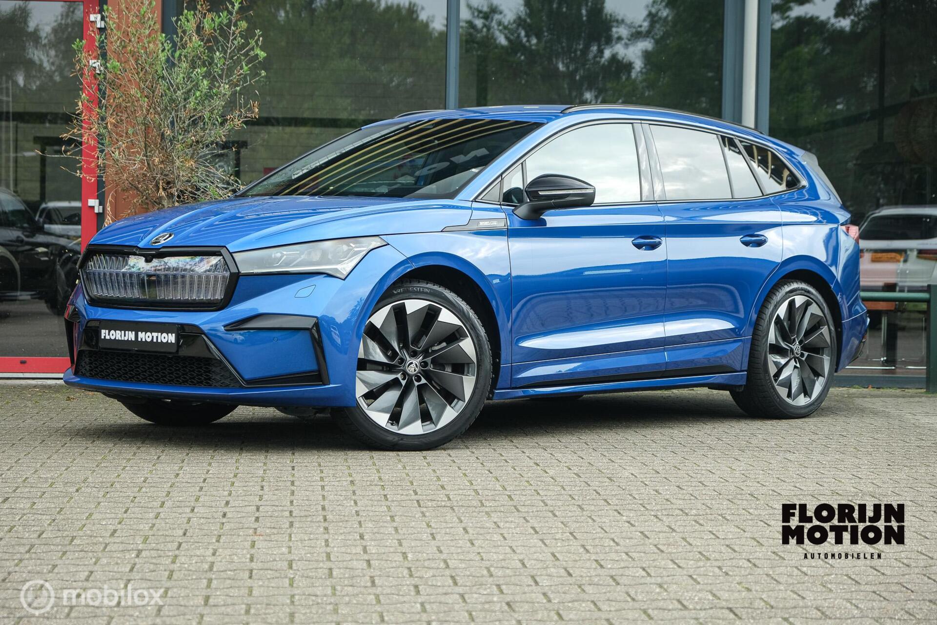 Skoda Enyaq Iv 80 Sportline | Chrystal lights and face | ACC | Elec. Trekhaak | Racing Blue | 90% SOH | Camera | Sfeerverlichting | 21 Inch | Memory | CarPlay | Stoel en stuurwielverw. 2022 - voorkant